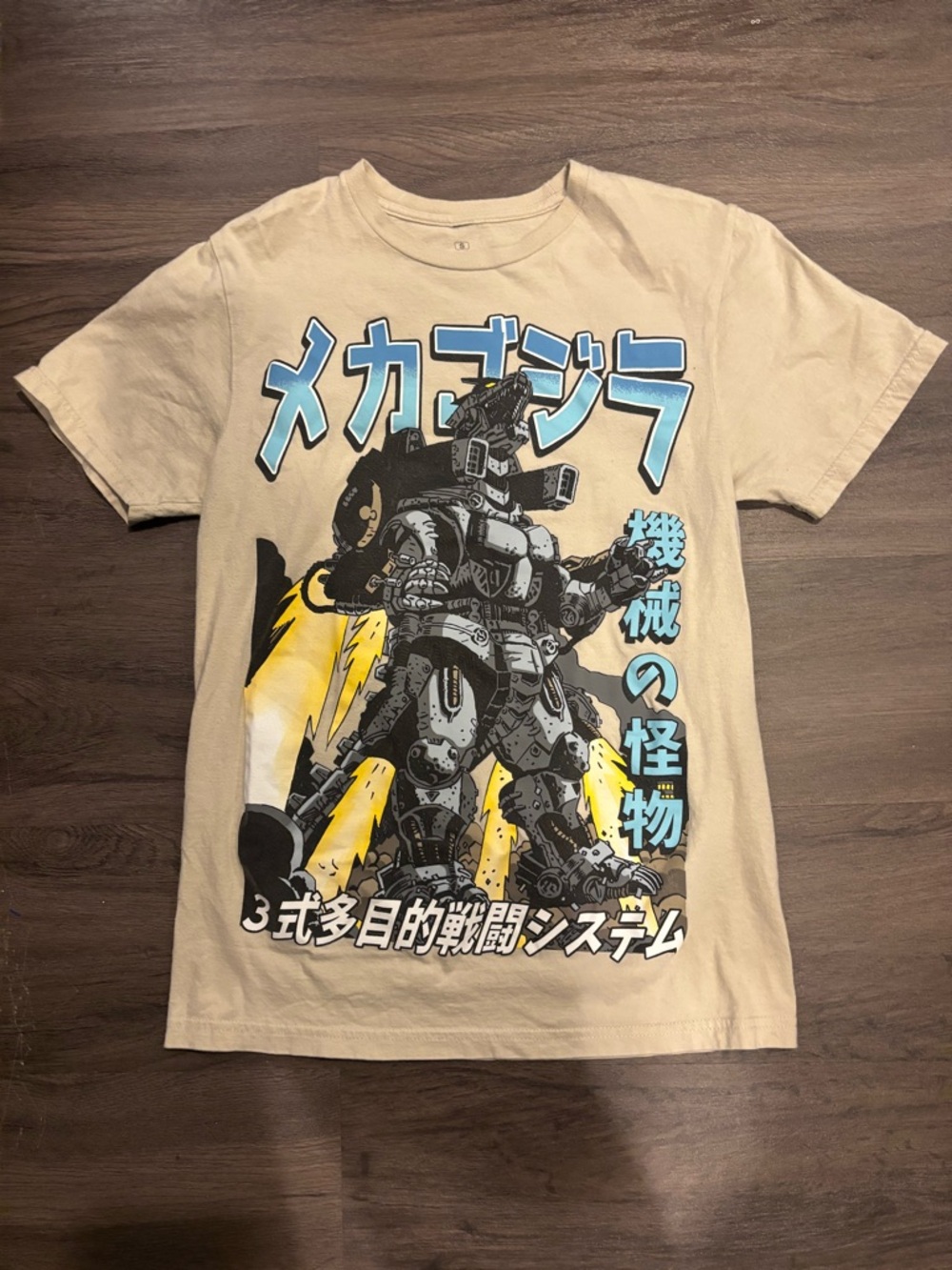 Ripple Junction Beige Tee with Blue and Yellow Mecha Graphic